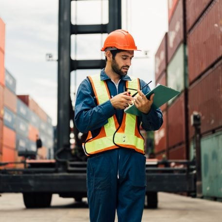 Worker in had hat and clipboard